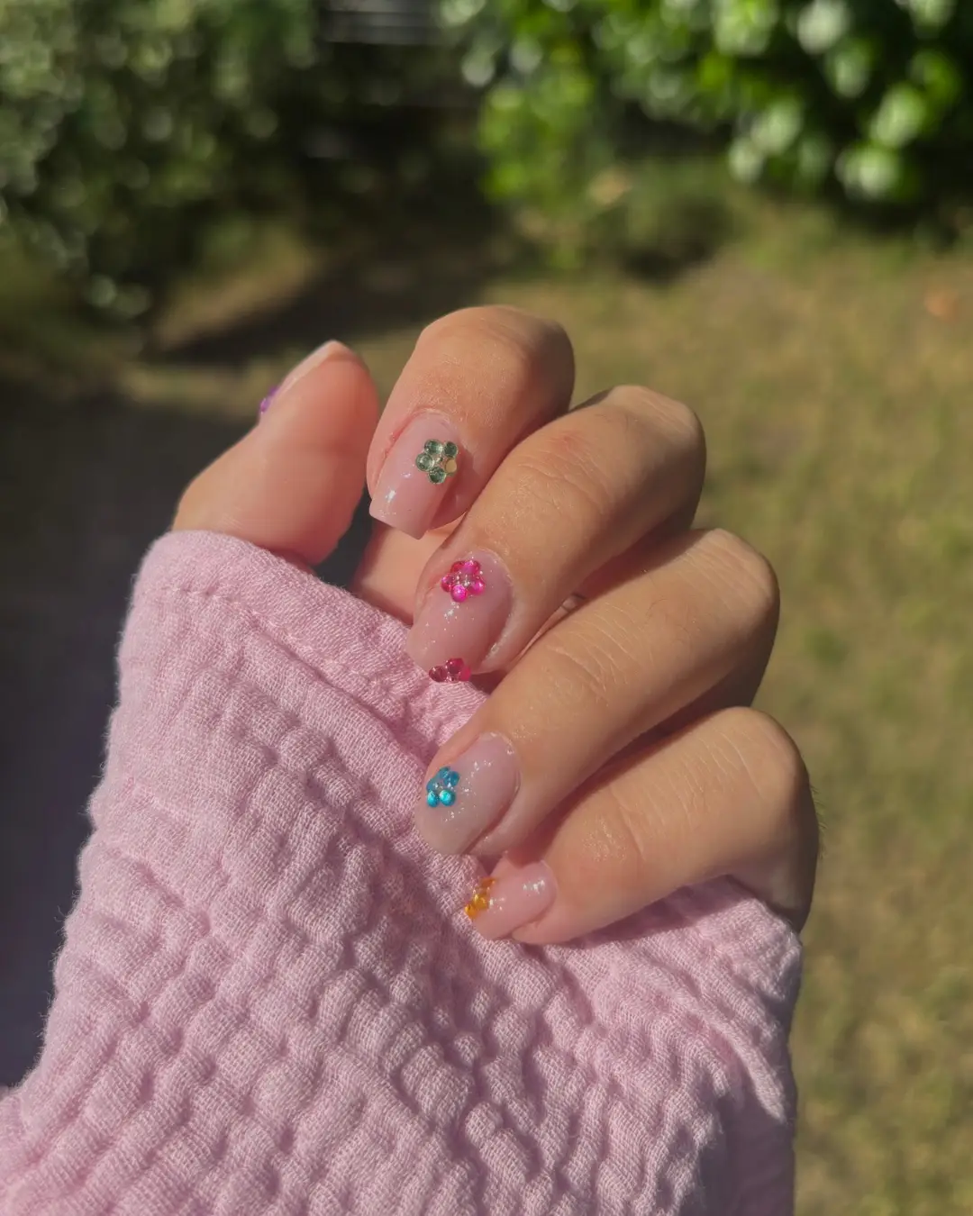 Nail art floral coloré sur base nude brillante